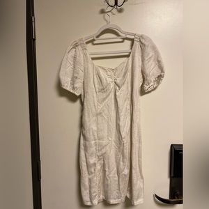 Beige colored, open back summer or spring dress.